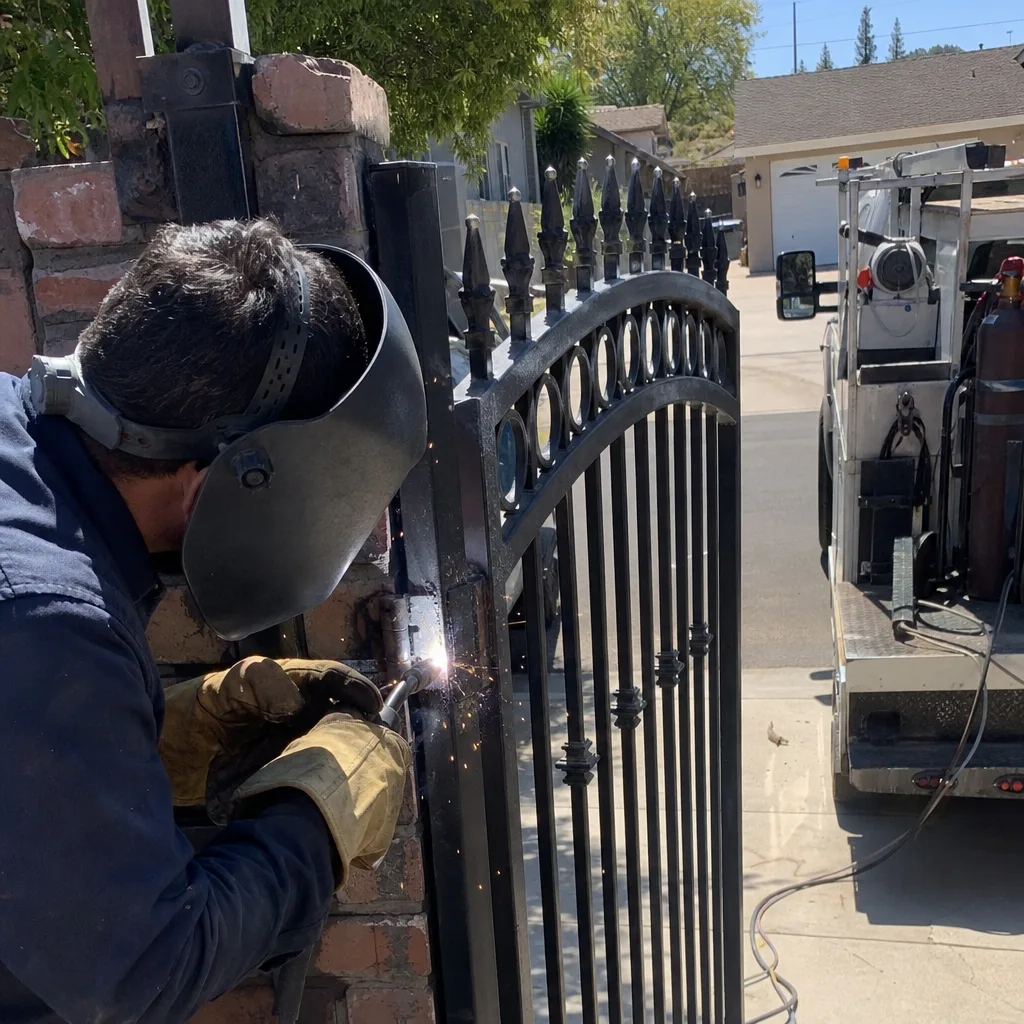Welder performing professional iron gate repair and metal fence maintenance in Northridge, CA